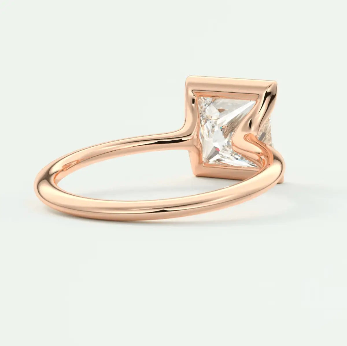 Rose gold princess cut diamond engagement ring with a square band.