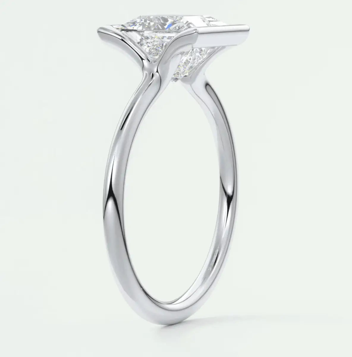 18-karat white gold engagement ring with a princess-cut diamond.