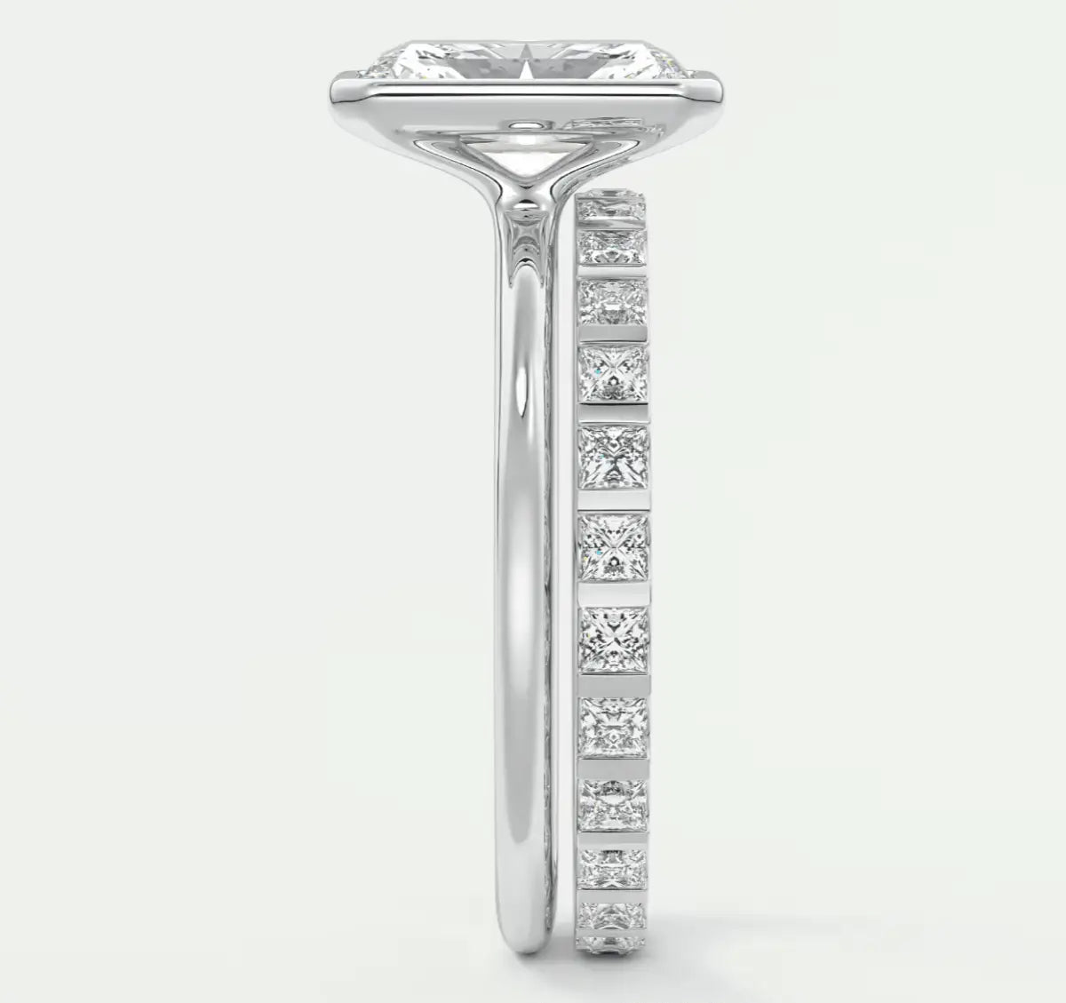 18k white gold diamond engagement ring with a princess cut center stone and channel set side stones.