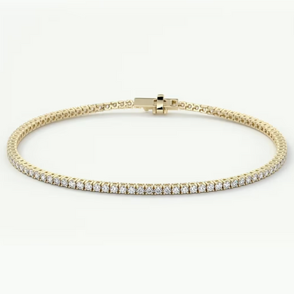 A yellow gold tennis bracelet featuring a row of round-cut clear gemstones on the front, displayed against a clean white background.