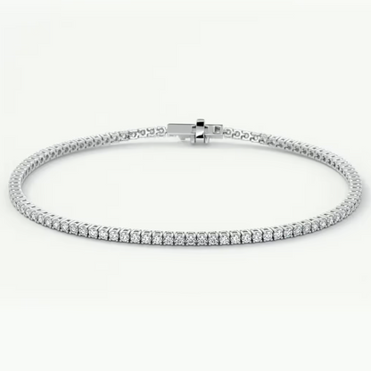 A white gold tennis bracelet with a continuous row of clear round-cut gemstones, displayed on a clean white background.