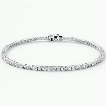 A white gold tennis bracelet with a row of clear round-cut stones along the front, displayed in a circular shape against a clean white background.