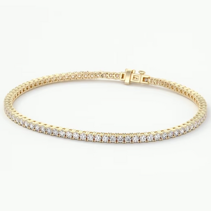 A yellow gold tennis bracelet featuring a single row of sparkling clear gemstones, displayed on a clean white background.