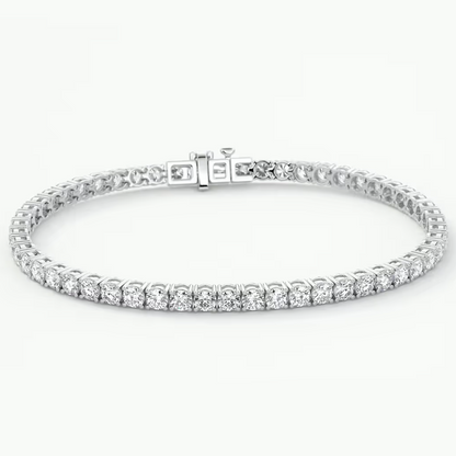 A white gold tennis bracelet with a row of round-cut clear gemstones, displayed on a clean white background.