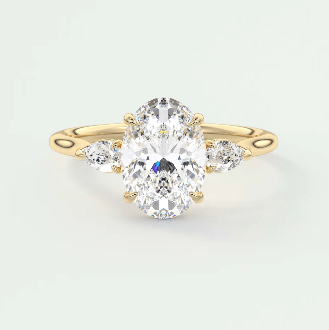 18k yellow gold oval diamond engagement ring with three smaller diamonds on each side.