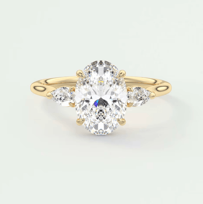 18k yellow gold oval diamond engagement ring with three smaller diamonds on each side.