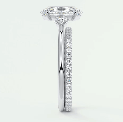 18-karat white gold engagement ring with a cushion-cut diamond center stone and pavé-set diamonds on the band.