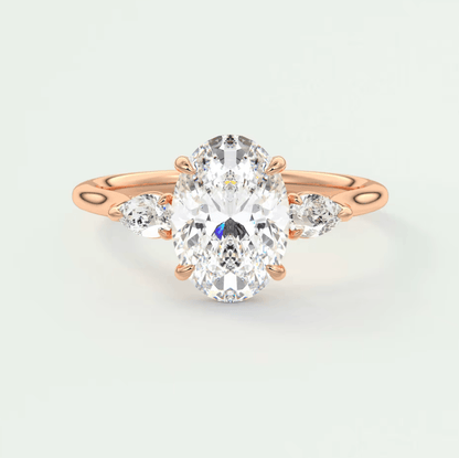 Rose gold diamond engagement ring with an oval center stone and marquise side stones.