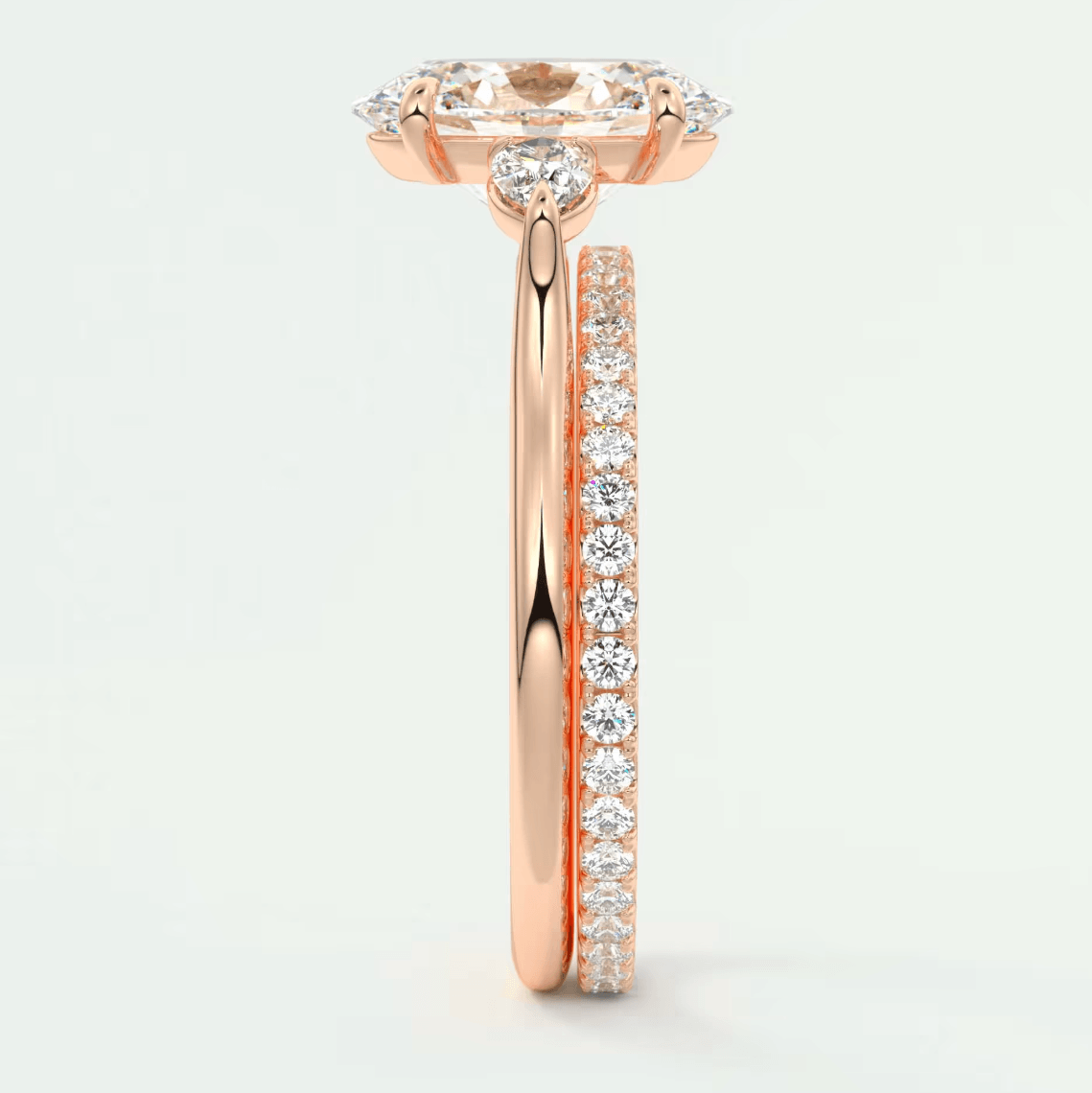 18-karat rose gold engagement ring with a marquise-cut diamond center stone and pavé set diamonds on the band.