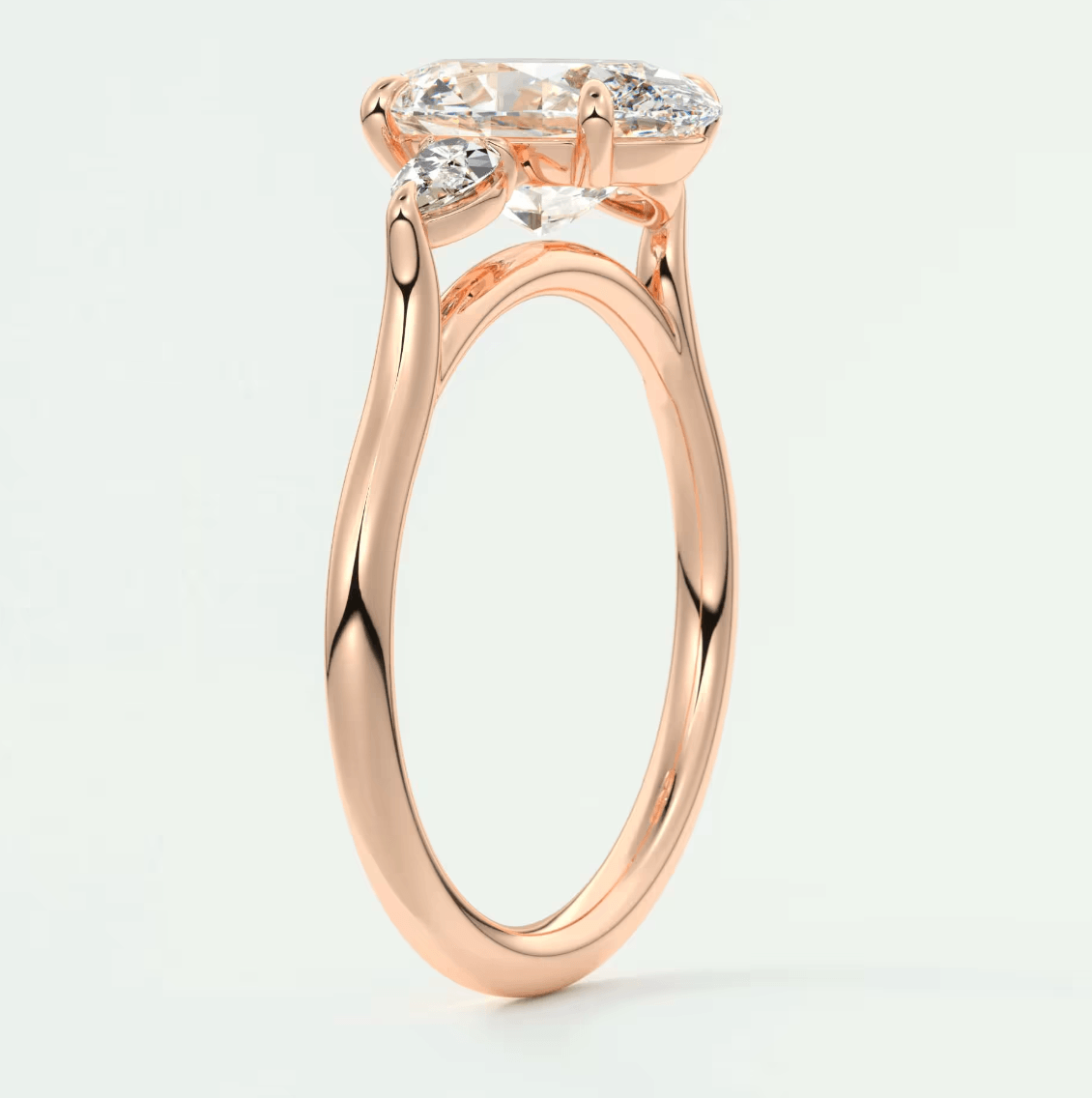 Rose gold engagement ring with marquise-cut diamond and small diamonds on band