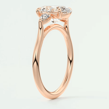 Rose gold engagement ring with marquise-cut diamond and small diamonds on band