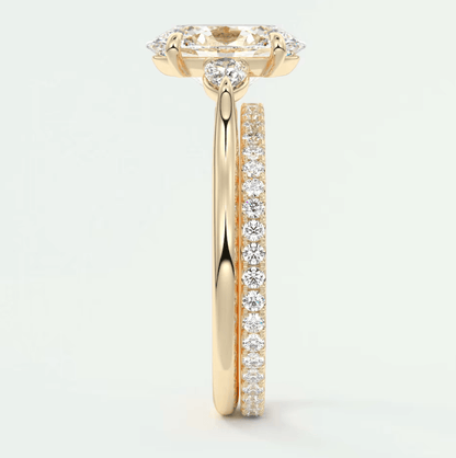 18k yellow gold engagement ring with a marquise diamond center stone and pavé set diamonds on the band.