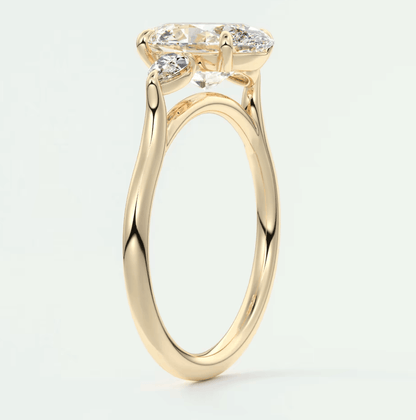 18k yellow gold engagement ring with a marquise-cut diamond and two smaller diamonds on each side.