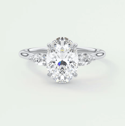18k white gold oval diamond engagement ring with three smaller diamonds on each side.