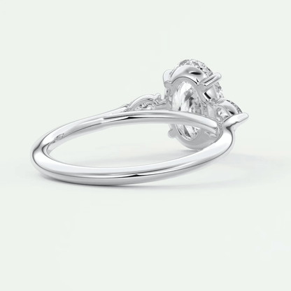 White gold engagement ring with a floral design and diamond center stone.