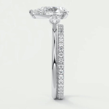 18k white gold diamond engagement ring with a marquise-shaped center stone and channel-set diamonds on the band.