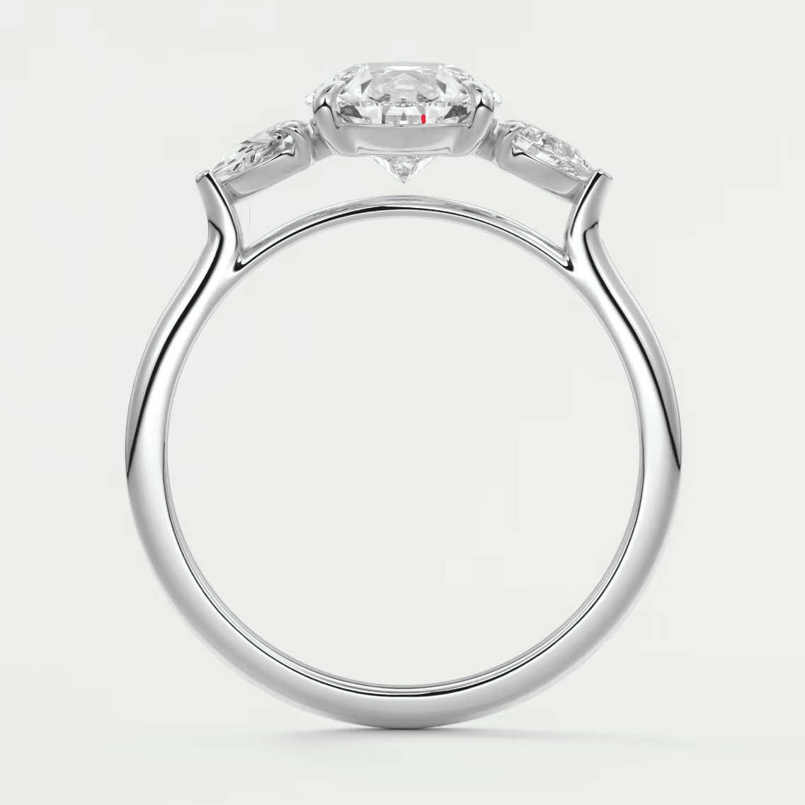18k white gold engagement ring with a round diamond center and two smaller diamonds on each side.