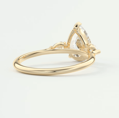 18k yellow gold engagement ring with a pear-shaped diamond.
