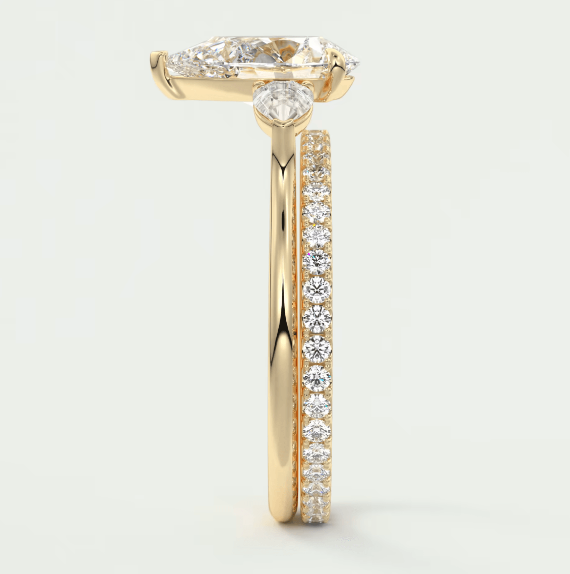 18k yellow gold diamond engagement ring with a marquise-cut center stone and pave set diamonds on the band.