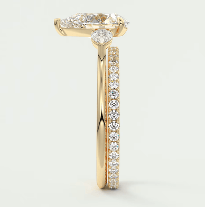18k yellow gold diamond engagement ring with a marquise-cut center stone and pave set diamonds on the band.