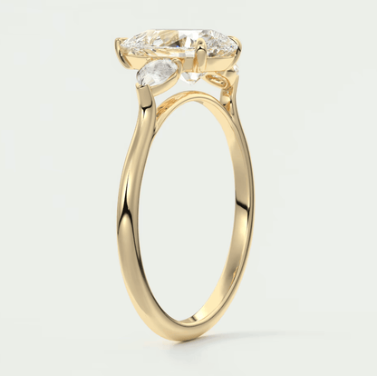 Yellow gold engagement ring with marquise-cut diamond and smaller diamonds on the band.