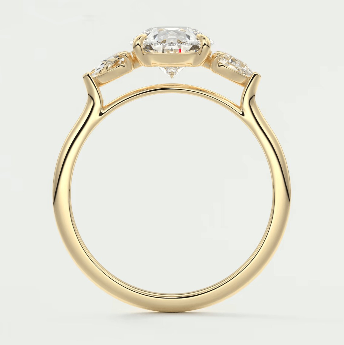 18-karat yellow gold engagement ring with a cushion-cut diamond and two smaller diamonds on either side.