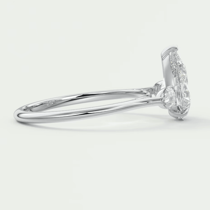 18k white gold diamond engagement ring with a marquise-cut center stone and halo of smaller diamonds.