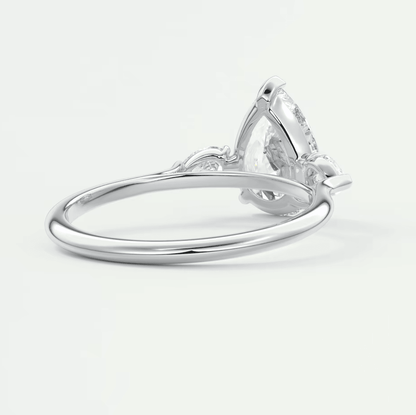 Pear-shaped diamond engagement ring with white gold band and claw setting.