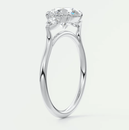 White gold engagement ring with three diamond stones set in a modern, twisted band design.