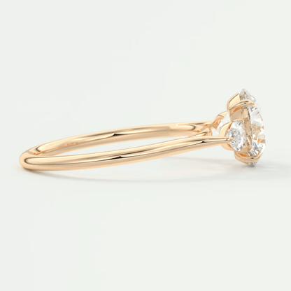 18-karat gold diamond engagement ring with a marquise-cut center stone and two smaller round diamonds on either side.