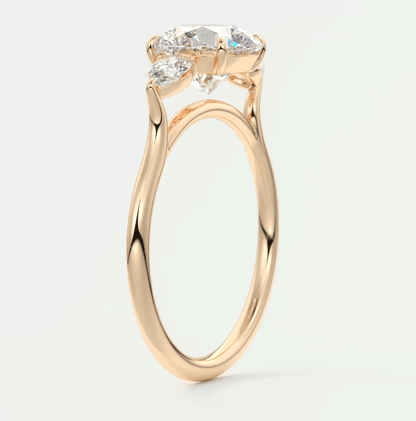 18-karat rose gold engagement ring with three diamond stones.