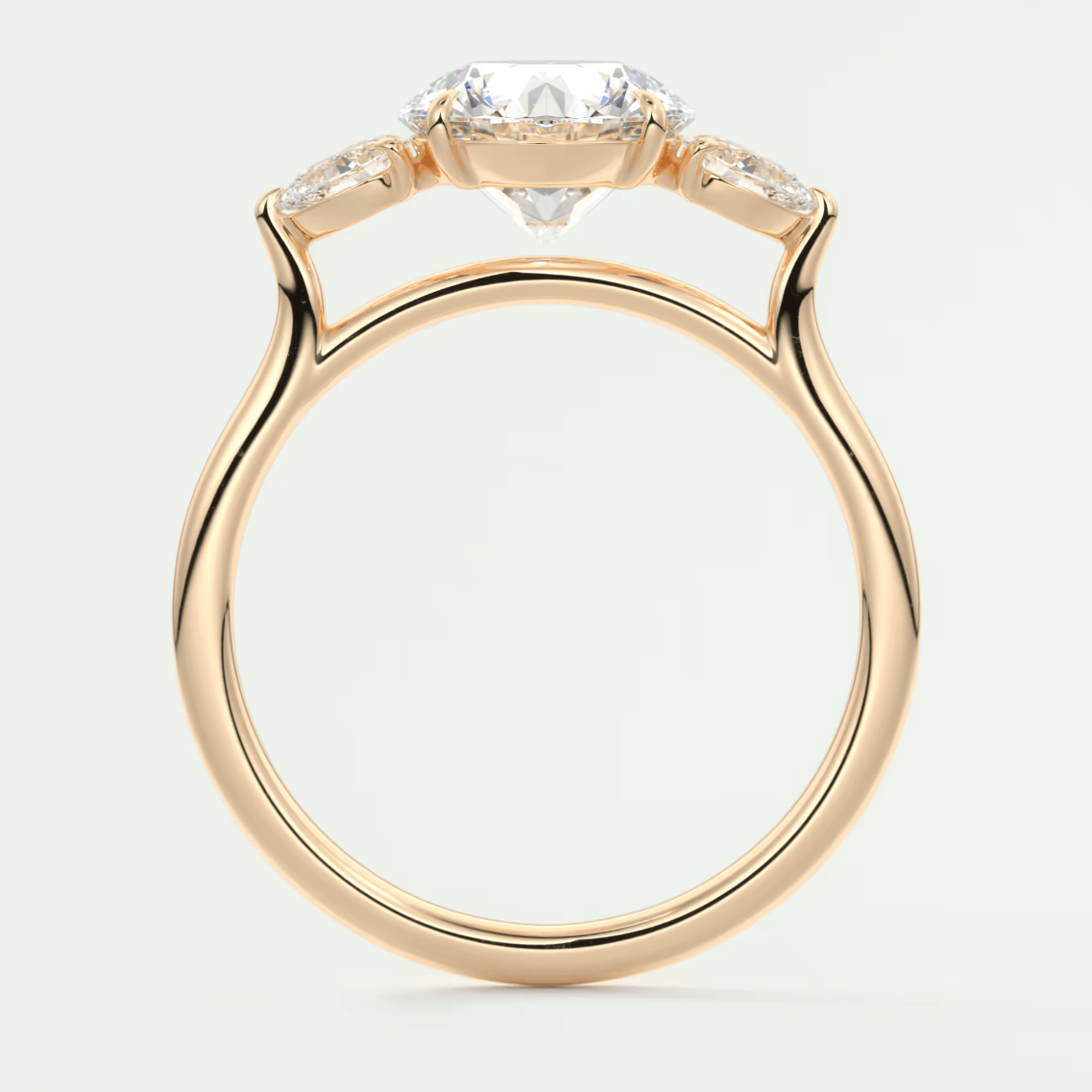 18-karat rose gold engagement ring with three diamond accents.