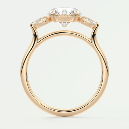 18-karat rose gold engagement ring with three diamond accents.