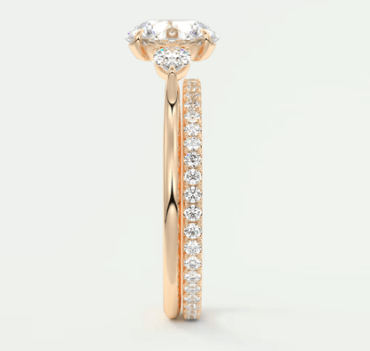 18k rose gold diamond engagement ring with a cushion-cut center stone and pavé band.