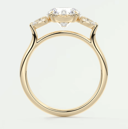 18-karat yellow gold engagement ring with a marquise-cut diamond and two smaller diamonds on either side.