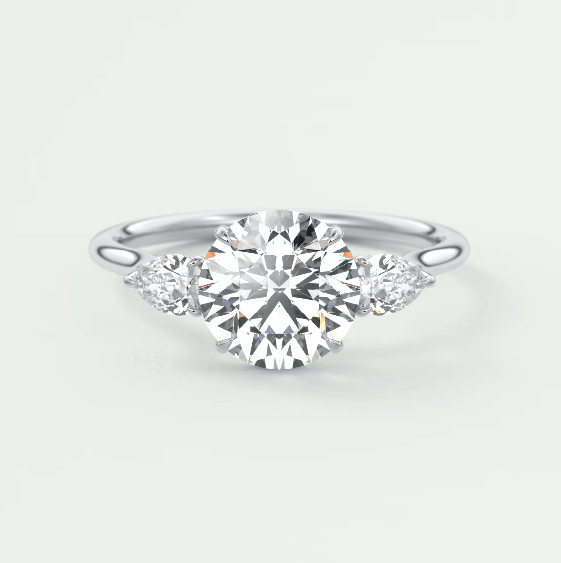 Diamond engagement ring with three prongs and a round center stone, set in white gold.