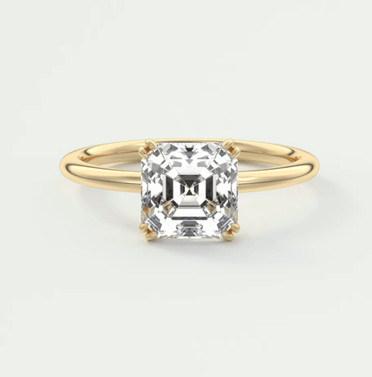 18-karat yellow gold engagement ring with a cushion-cut diamond.