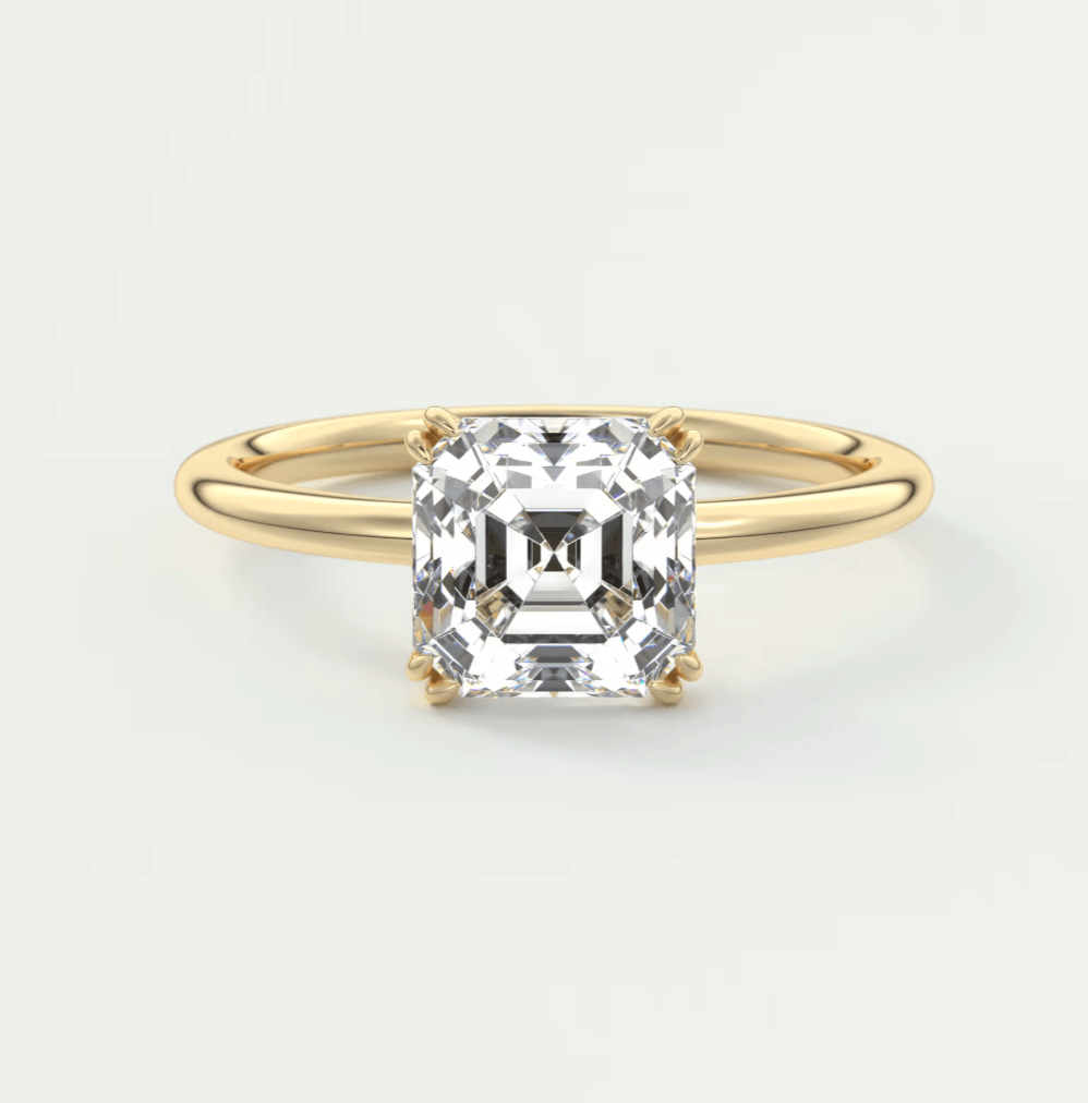 18-karat yellow gold engagement ring with a cushion-cut diamond.