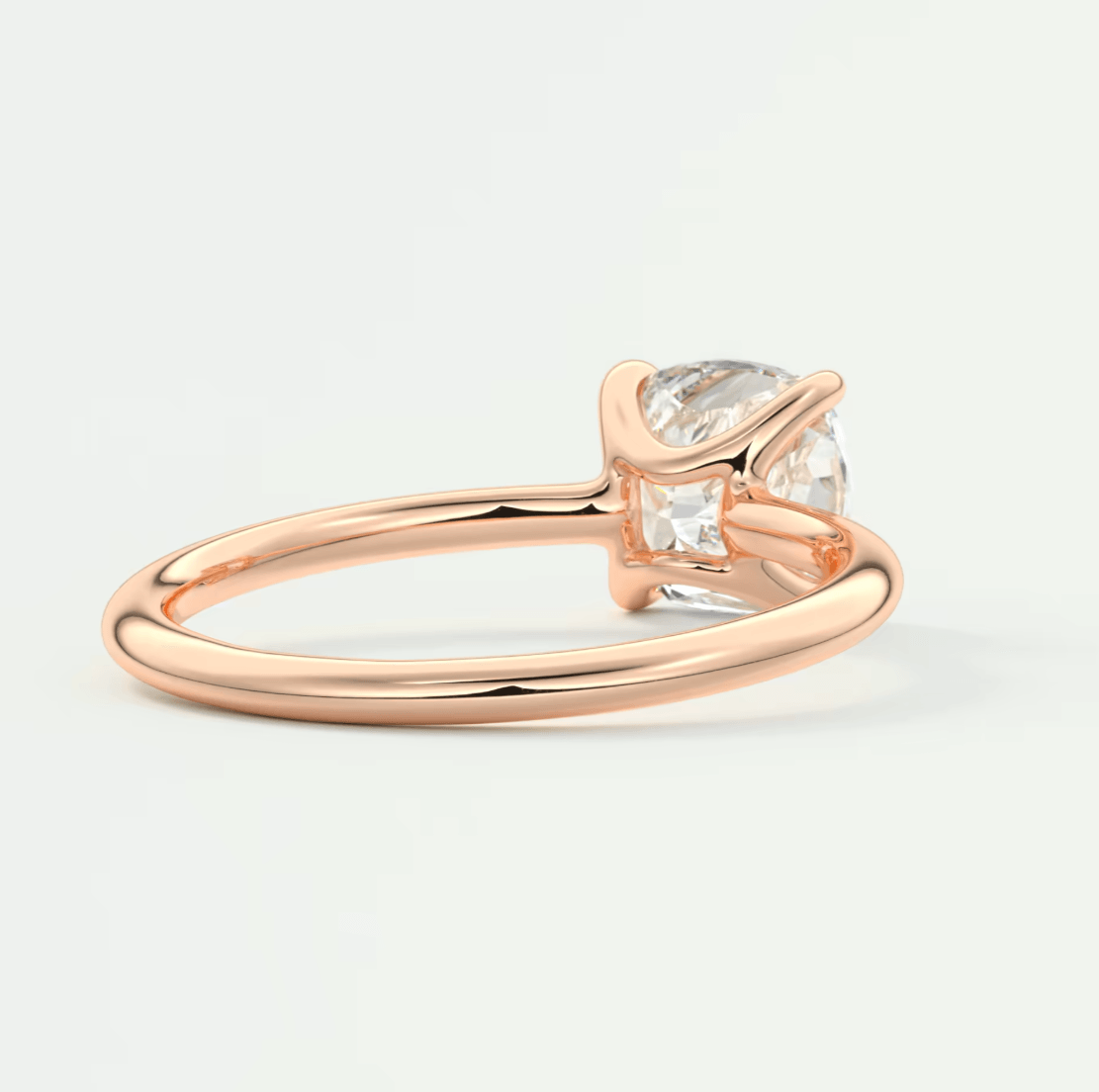 Rose gold engagement ring with a pear-shaped diamond and baguette side stones.