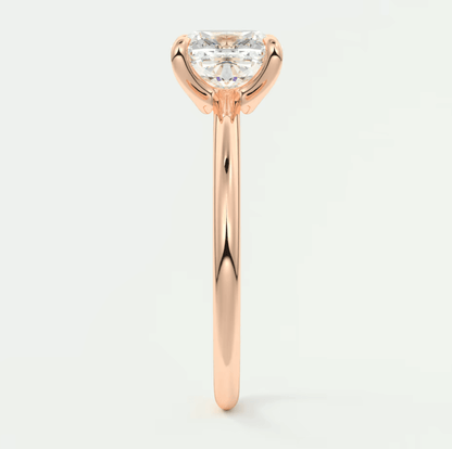 18-karat rose gold engagement ring with a heart-shaped diamond.