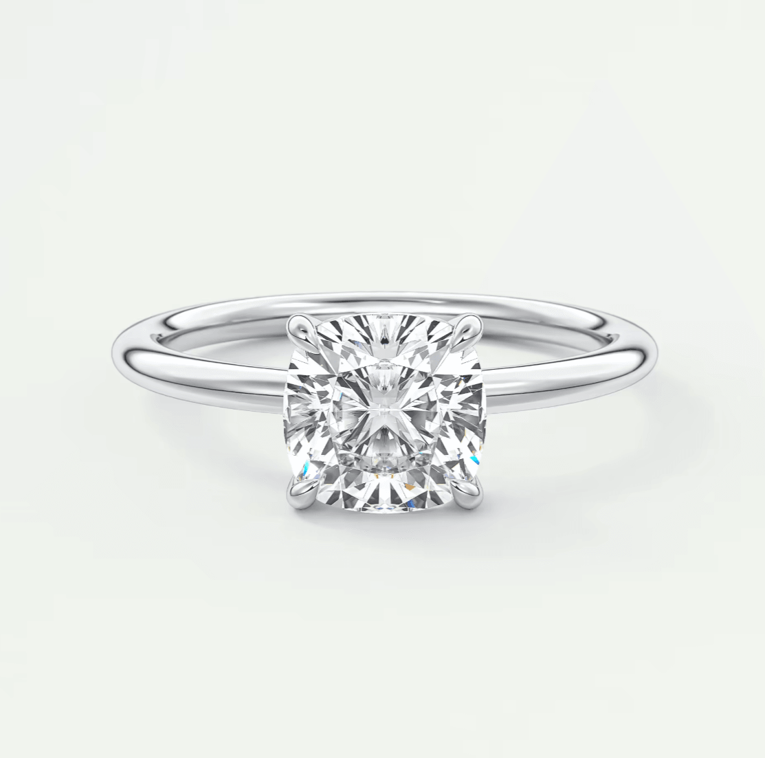 18-karat white gold cushion-cut diamond engagement ring.