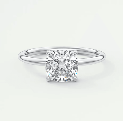 18-karat white gold cushion-cut diamond engagement ring.