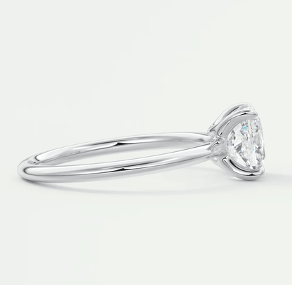 18-karat white gold solitaire engagement ring with a round diamond.