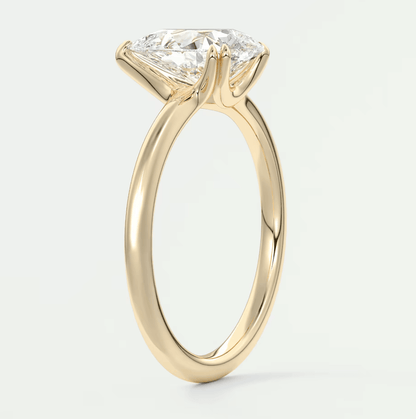 18-karat yellow gold engagement ring with a princess-cut diamond.