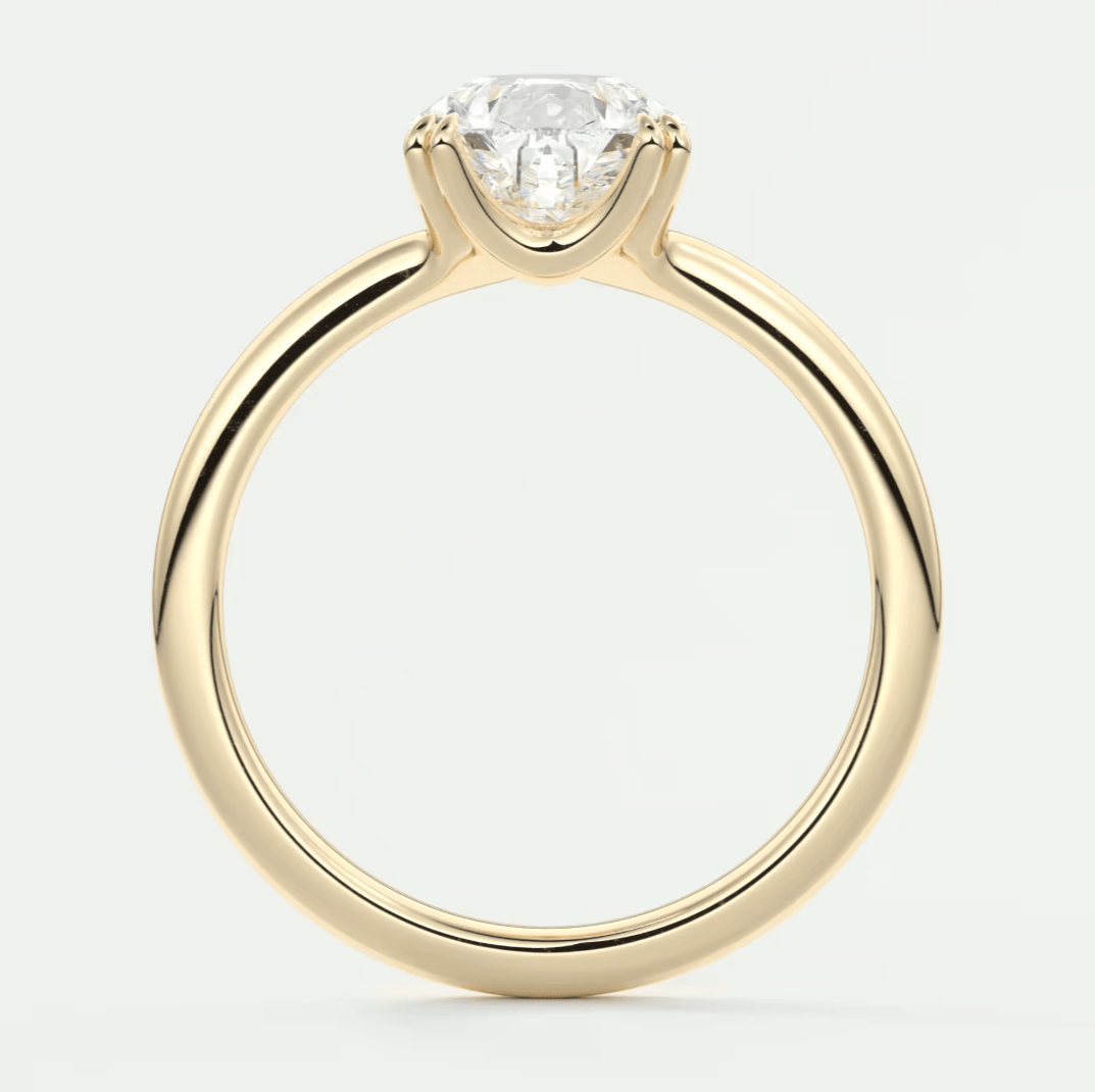 18-karat yellow gold solitaire engagement ring with a round diamond.