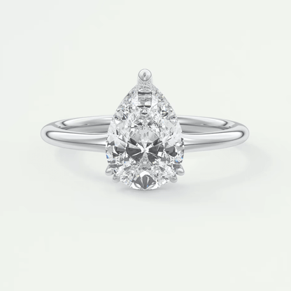 Pear-shaped diamond engagement ring with white gold band and prong setting.