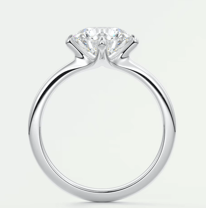 Silver solitaire diamond engagement ring with a classic four-prong setting.