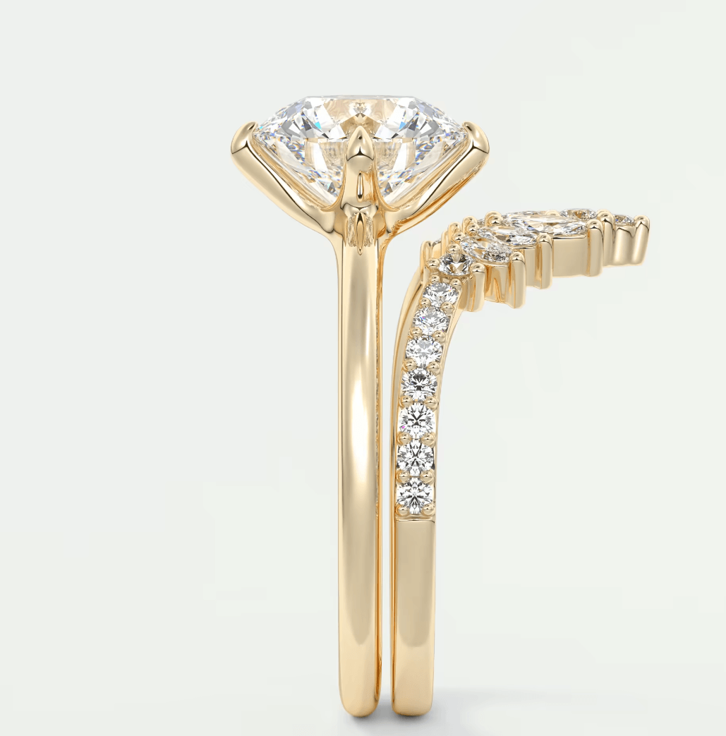 18k yellow gold engagement ring with marquise-cut diamond and pave-set diamonds on the band.