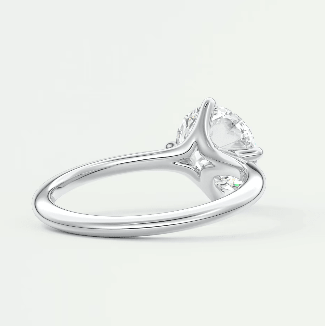 18-karat white gold engagement ring with a marquise-cut diamond.
