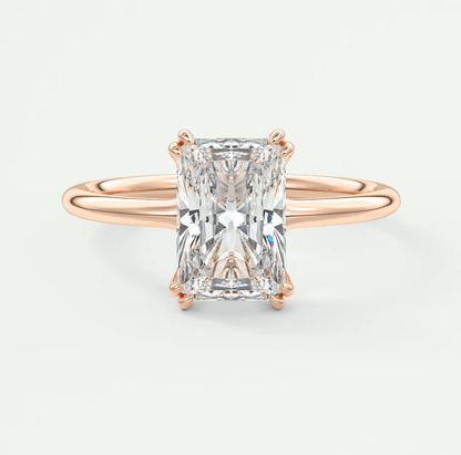 Rose gold diamond engagement ring with a rectangular cut gemstone.